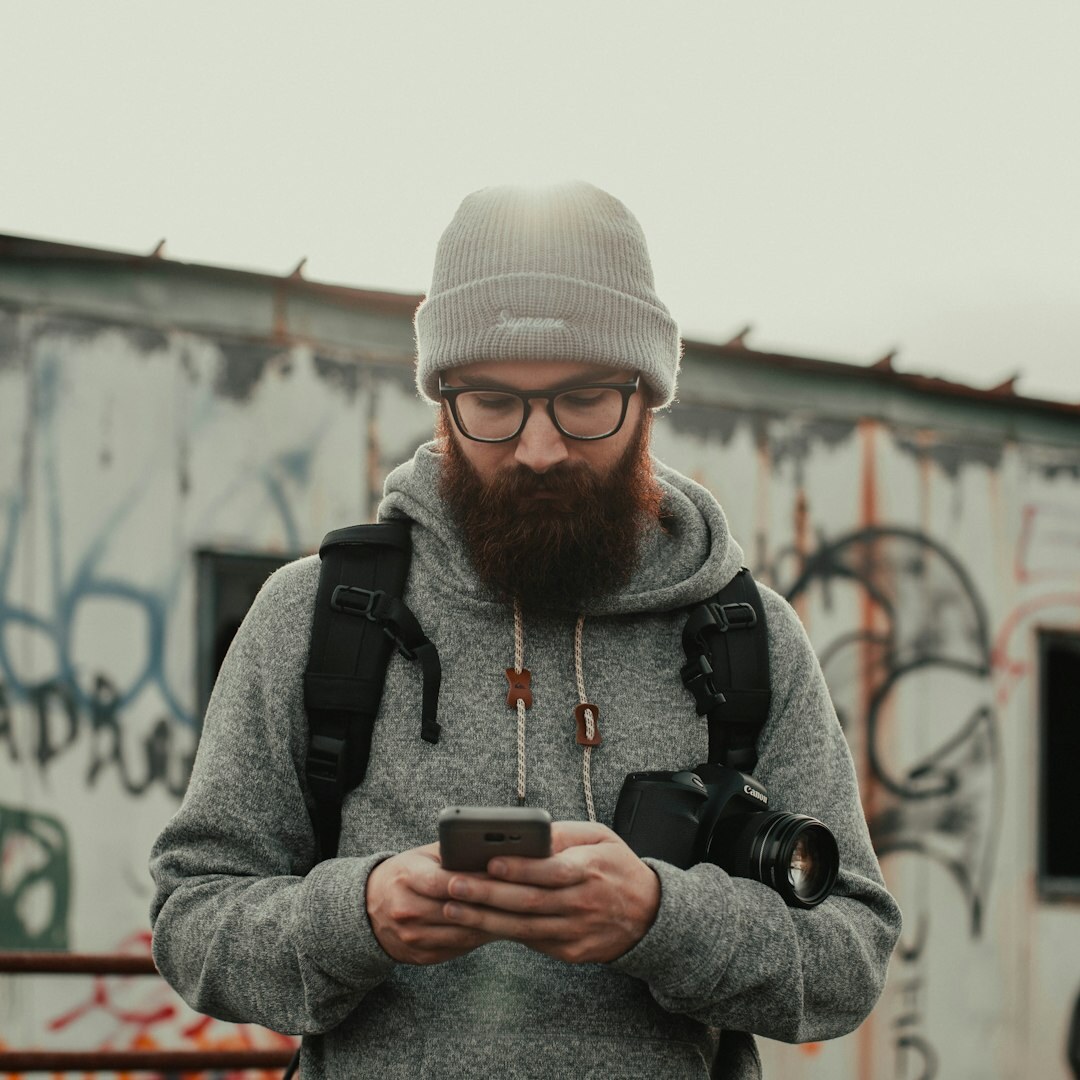 Professional male journalist with beard and glasses